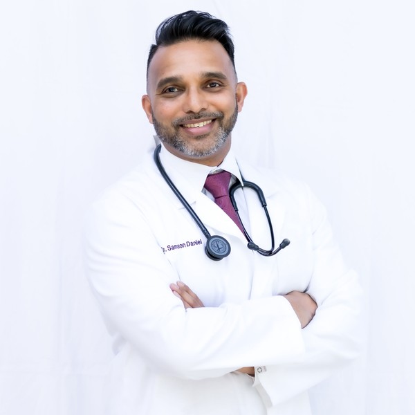male veterinarian with a dog wearing stethoscope