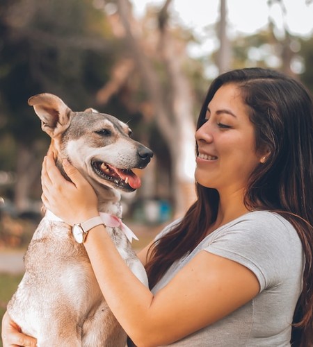 woman petting her dog